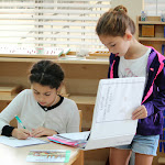 Our students learn to be organized. Here, you can see a student looking through her work binder as she decides what activity to work on next.
