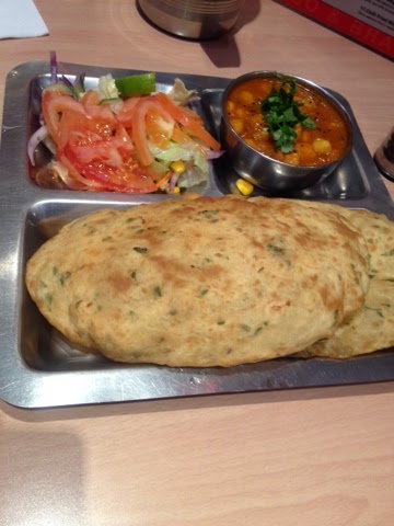 Chickpea curry with deep-fried bread chickpea curry with salad and roti