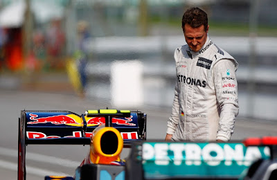 Михаэль Шумахер рассматривает болид Red Bull после квалификации на Гран-при Малайзии 2012