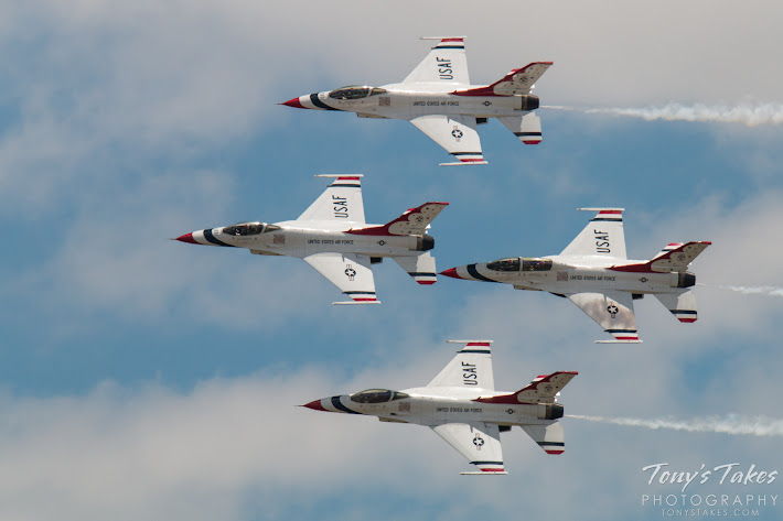 A four ship of the U.S. Air Force Thunderbirds performs a flyby.  (© Tony’s Takes)