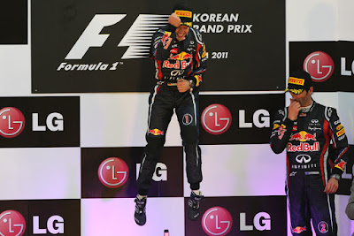 прыжок Себастьяна Феттелья и Марк Уэббер вытирающий нос на подиуме Гран-при Кореи 2011