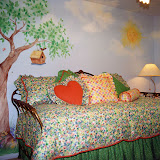 Khamilah's Bedroom 1 of 2 - This little girl's bedroom features a mural that creates a garden atmosphere. The bedding is all reversible, allowing the child to create many looks.
