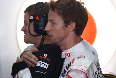 Дженсон Баттон обнимает своего механика сзади на Гран-при Бразилии 2011