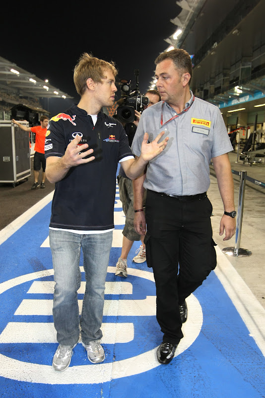 Себастьян Феттель разговаривает с инженером Pirelli после гонки на Гран-при Абу-Даби 2011