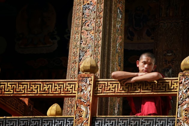 Buddhist Monk from the balcony of a temple in Punakha Dzong, Bhutan