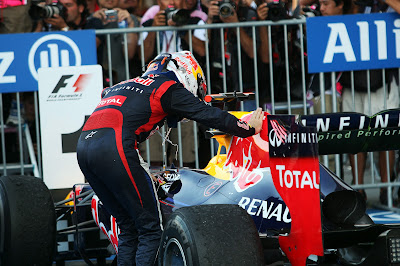 Себастьян Феттель гладит свой болид Red Bull после победы на Сузуке на Гран-при Японии 2012