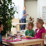 At the Emeryville campus, children sit down for a restaurant style lunch. Setting up the table with placemats, napkins, plates and silverware is the children's job. Having a nice setting like this encourages a civilized, well-mannered lunch experience.