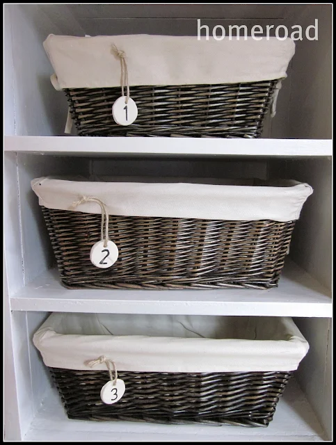 Three stacked baskets with clay hanging tags