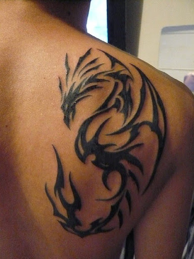 tribal dragon tattoos on upper back shoulder of a man