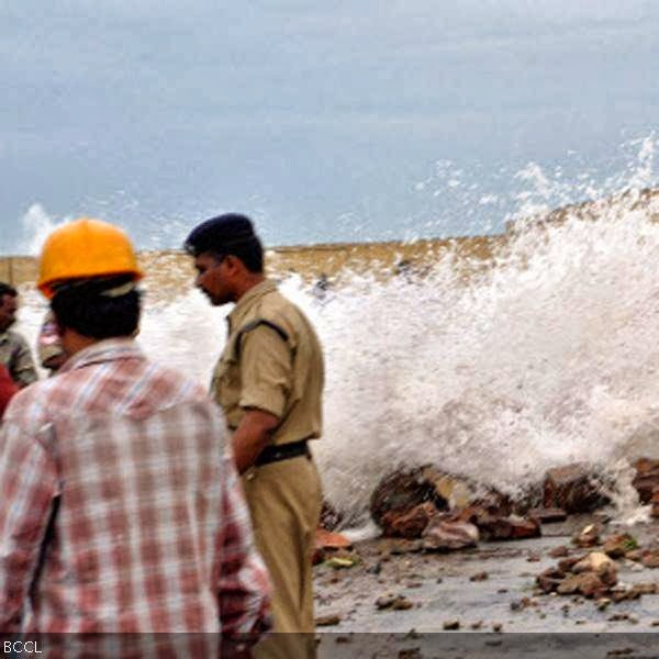 Visakhapatnam: Security personnel look at the turbulent waves created by cyclone Phailin 