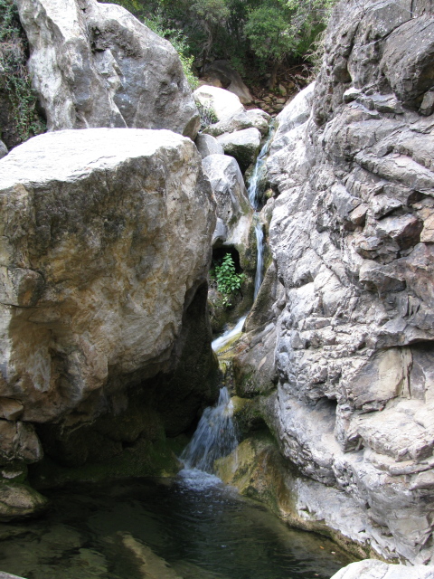 water tumbling down a narrow crack in the rocks