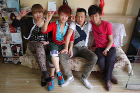 four young people wearing a variety of fashions sitting on a couch in Yinchuan, China