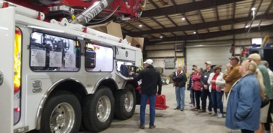 A group of people standing next to a truck

Description automatically generated with low confidence