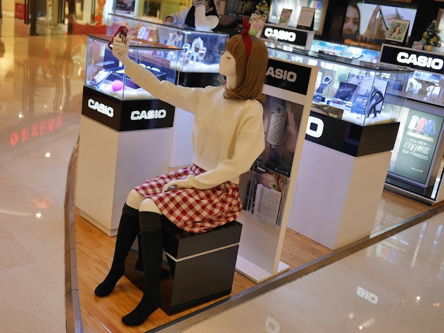 mannequin taking a selfie in front of displays for Casio products
