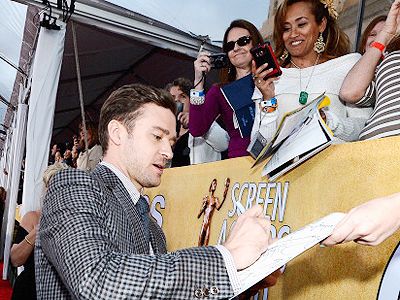 Justin Timberlake signs autographs during the 19th Annual Screen Actors Guild Awards, held at The Shrine Auditorium in Los Angeles on January 27, 2013. (Getty Images)