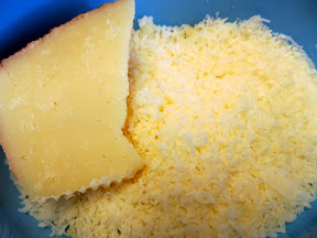 Ingredients for a recipe of Cauliflower with Manchego and Almond Sauce- grating Manchego