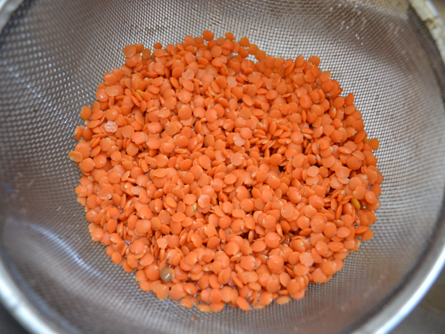 lentils being rinsed in strainer 