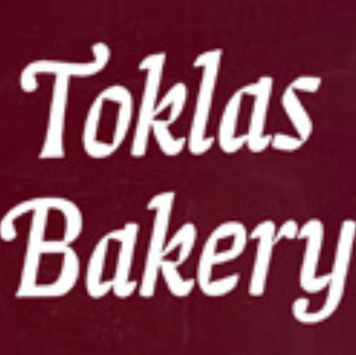 Toklas Cafe and Bakery logo