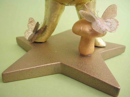 The star base was sponge-painted gold and embellished with a cute little gold-painted mushroom and a couple of more butterfly stickers. The star base was sponge-painted gold and embellished with a cute little gold-painted mushroom and a couple of more butterfly stickers.