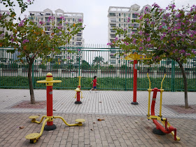 Public exercise equipment and a child running by