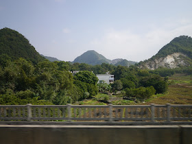 scenic view of mountains from train window while heading from Guangzhou to Changsha