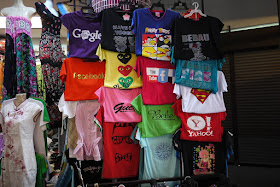 a variety of shirts including those with logos for Google, Facebook, YouTube, and Yahoo