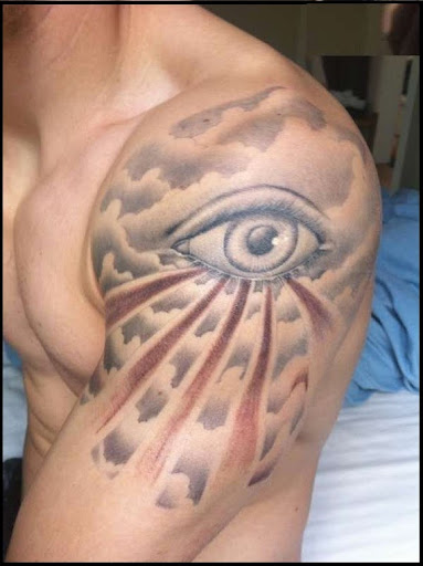 Cloud tattoo with eye on the shoulder