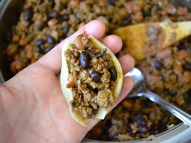 close up of one shell pasta filled with taco filling 