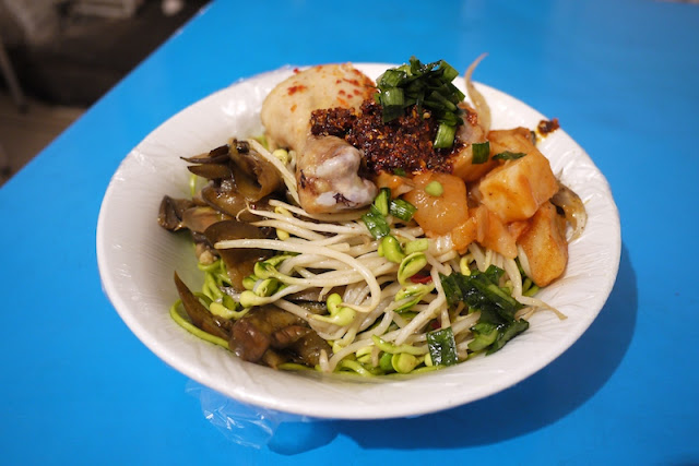 green noodles with toppings at Zhengning Street Night Market in Lanzhou, China