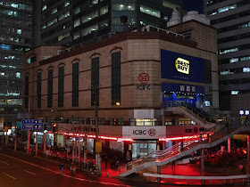 Best Buy sign lit up at night at the old Best Buy store in Shanghai, China