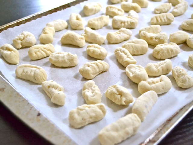 gnocchi placed on baking sheet lined with parchment paper ready to freeze 