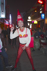 bachelor in Changsha with a painted face and wearing red women's underwear, a red hat, and Chinese flags