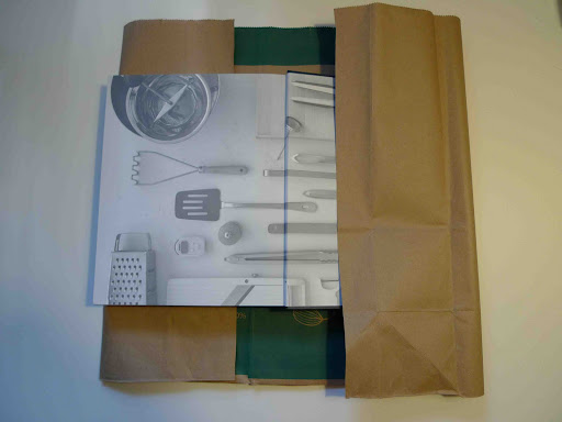 Secure the flap with the book itself, and open the back cover. Trim any excess, and then fold the bag to create the back flap. Secure the flap with the book itself, and open the back cover. Trim any excess, and then fold the bag to create the back flap.