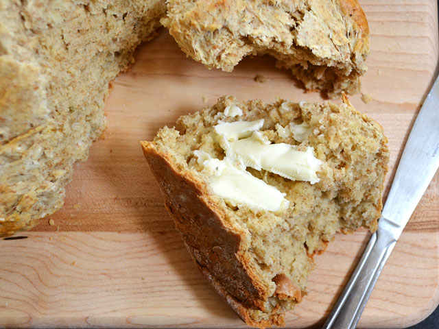 close up of a piece of brown butter soda bread with butter 