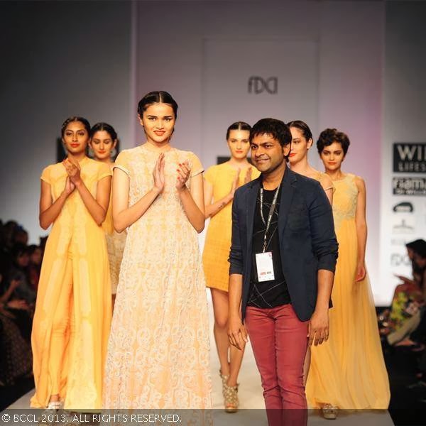 Fashion designer Manish Gupta walks the ramp with the models on Day 2 of Wills Lifestyle India Fashion Week (WIFW) Spring/Summer 2014, held in Delhi.