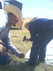 Levi helps Randal drive teepee stakes