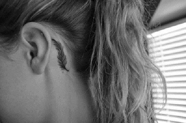 small feather tattoo behind ear