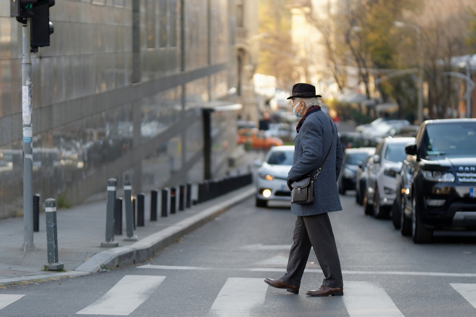 an elderly man crossing the pedestrian lane