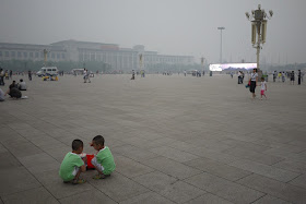 twin boys squatting at Tiananmen Square