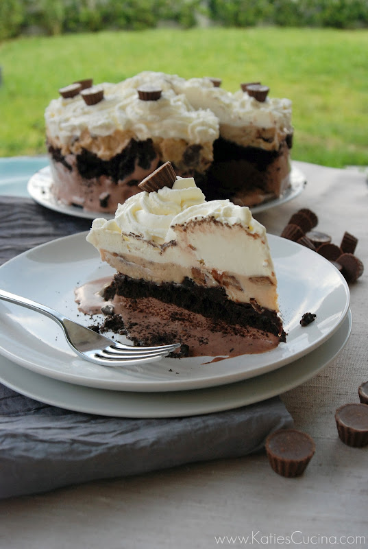 A slice of peanut butter chocolate ice cream cake on two white plates stacked with a fork on the side.