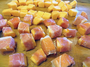 Prosciutto wrapped cantaloupe with red pepper lime oil and manchego recipe: wrapping the prosciutto around the cantaloupe pieces