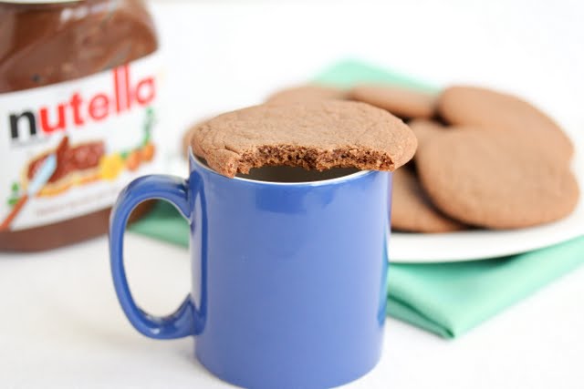 photo of a cookie on top of a coffee mug