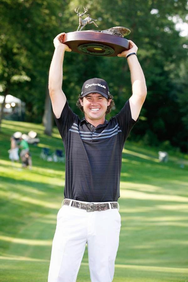 Brian Harman holds the trophy after winning the John Deere Classic held at TPC Deere Run, on July 13, 2014, in Silvis, Illinois. 