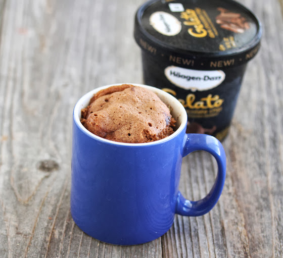 photo of a Chocolate Ice Cream Mug Cake with a carton of ice cream in the background