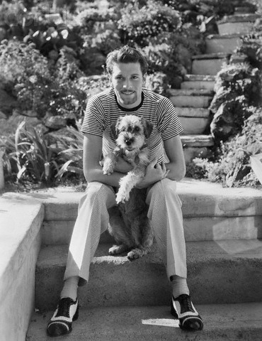 Laurence Olivier holding a dog