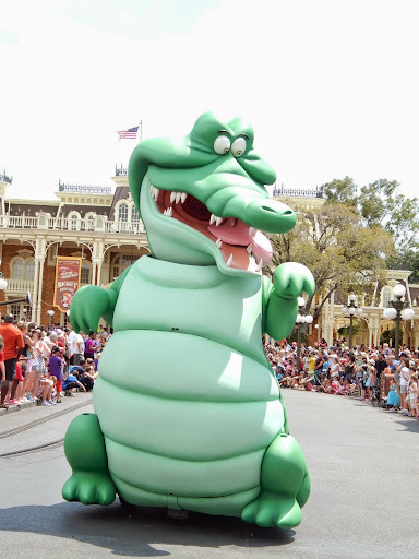 New Disney World Parade: Festival of Fantasy. The crocodile follows closely behind, licking his lips hungrily. 