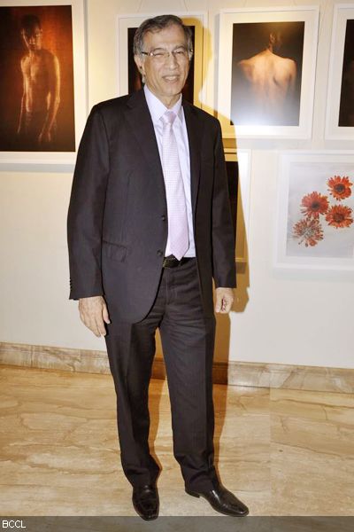 Niranjan Hiranandani smiles into the camera during a photo exhibition, held at Tao art gallery in Mumbai on February 1, 2013. (Pic: Viral Bhayani)