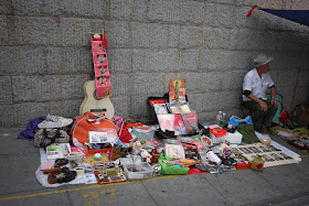 various items on the ground for sale outside Tianxinge Antique City in Changsha, China