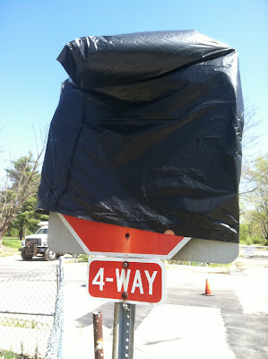 covered stop sign garbage bag 4way stock photo