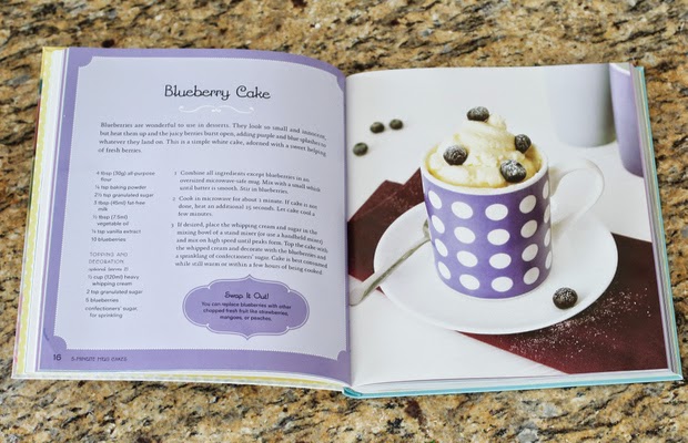 photo of a cookbook opened to the blueberry mug cake recipe